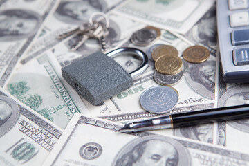 Padlock on the dollar bills. Close up. Business concept.