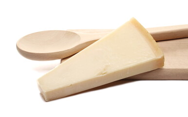 Cheese wedge, Italian Grana Padano triangle block with wooden spoon on chopping board isolated on white background