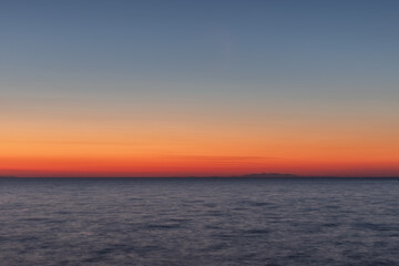 Fototapeta na wymiar Sunset landscape with coastline and mountains