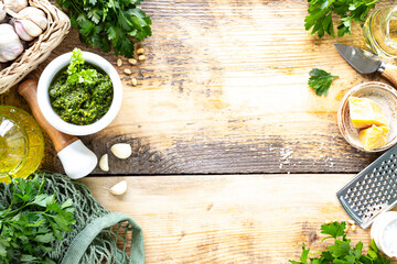 Parsley pesto sauce and ingredients for cooking. Top view. Copy space