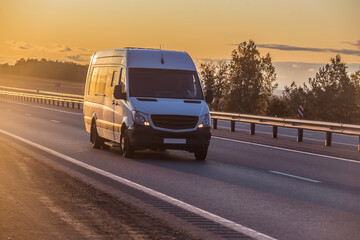 minibus moves along suburban highway