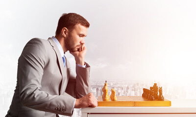 Businessman moving chess figure in chessboard