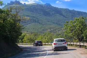 Cars move along a winding highway in the highlands