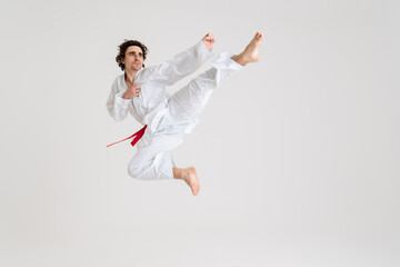Young caucasian sportsman dressed in kimono practice in karate © Drobot Dean