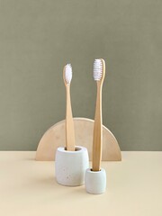 Bamboo toothbrushes in concrete stands, geometric shape props for product photography
