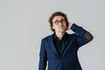 Brooding handsome man in eyeglasses thinking and looking aside