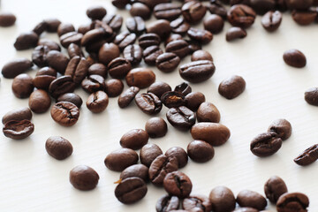 roasted coffee beans on white wooden background
