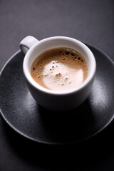 Cup of coffee on black background. Close up. 