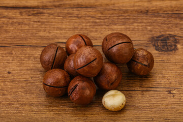 Brown macadamia nut heap over background