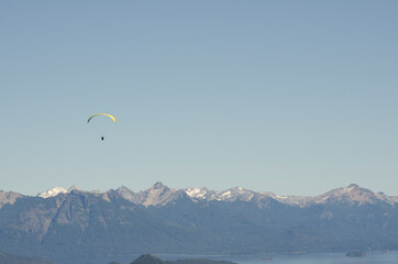Paaglider flying over the mountain range, horizontal with copy space