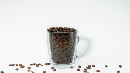 Cup of coffee beans on white background
