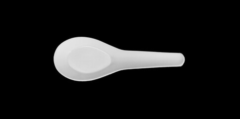 Plastic spoon on black background