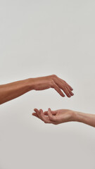 Close up of two open cupped hands with empty space between them isolated over light background