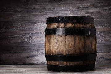 Old wooden barrel standing on table in old cellar