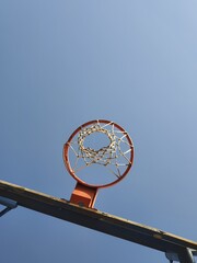 basketball hoop against blue sky © evenotim