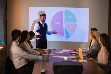 Diagram. Male speaker giving presentation in hall at university workshop. Audience or conference hall. Participants, co-workers listening at the table.. Scientific, business event, training. Education