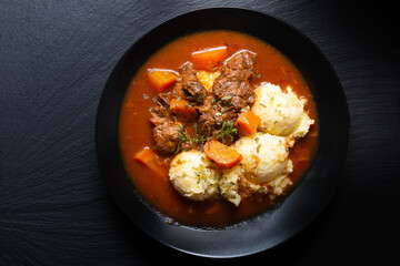 Food concept Spot fosuc Homemade classic beef stew with mashed potato in black dish with copy space