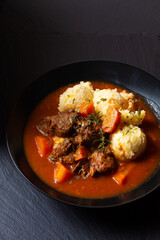 Food concept Spot fosuc Homemade classic beef stew with mashed potato in black dish with copy space