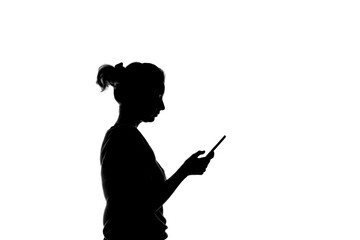 Black and white silhouette of a girl who holds a smartphone in her hands