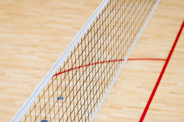 Elementary school gym indoor with volleyball net. Team sport concept.