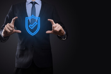 Protection network security computer in the hands of a businessman. business, technology, cyber security and internet concept - businessman pressing shield button on virtual screens Data protection