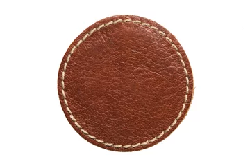 Deurstickers Blank brown round leather label on white background, macro close up. Empty leatherette circular tag © JpegPhotographer