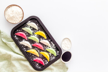 Top view of colorful raw dumplings on baking sheet