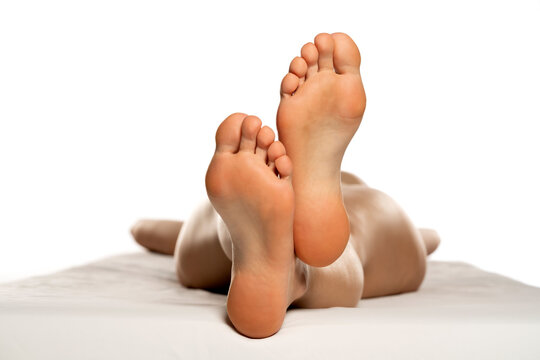 female soles on a white bed