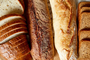 Top view of various kinds of bread on a wooden surface.