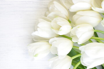 Obraz premium White fresh tulips on wooden background, nice tender spring flowers on wood texture, tulip bouquet frame, 8 March, Valentine, mother day birthday wedding gift 