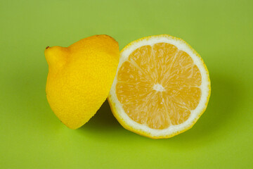 Yellow ripe lemon on a green background. Citrus tropical fruit