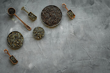 Top view of various tea in iron bowls and spoons. Asian tea ceremony