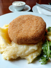 Fried breaded cheese and mashed potatoes gourmet lunch. 