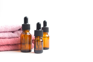 Brown glass bottles with serum, essential oil or other cosmetic product. Natural organic cosmetic packaging, skin care concept.