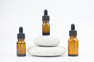 Brown glass bottles with serum, essential oil or other cosmetic product. Natural organic cosmetic packaging, skin care concept.