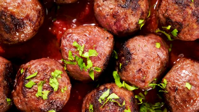 grilled meatballs with tomato sauce and herbs