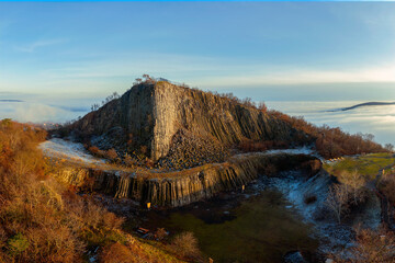 Amazing geological formatoion with fog. Basalt columns hill in upper Balaton region in Hungary. The...