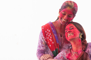 TWO WOMEN HAPPILY POSING TOGETHER AFTER CELEBRATING HOLI	