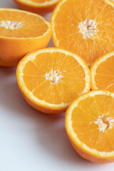 The orange halves are on the table. On a gray and white background.