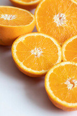 The orange halves are on the table. On a gray and white background.
