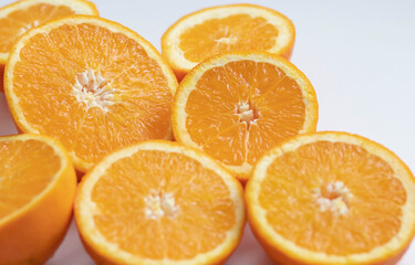 The orange halves are on the table. On a gray and white background.