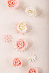 Fototapeta na wymiar Homemade white and pink marzipan roses
