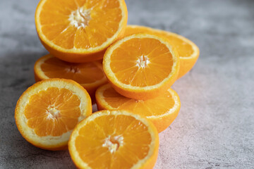 The orange halves are on the table. On a gray and white background.