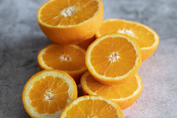 The orange halves are on the table. On a gray and white background.