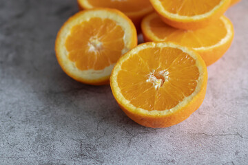 The orange halves are on the table. On a gray and white background.