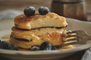 Delicious homemade cheesecakes, cut with a fork sprinkled with fresh blueberries,