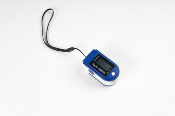 Portable digital fingertip pulse oximeter isolated on white background.