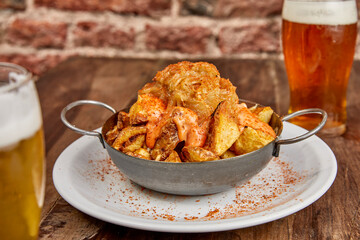 Patatas bravas, Spanish dish with fried potato and a spicy ali oli sauce.