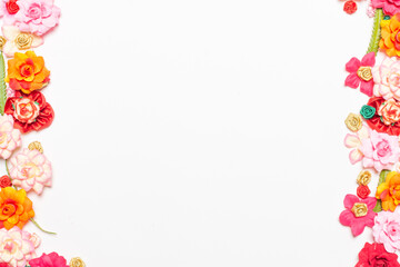 Frame made of rose flowers on white background. Top view with copy space.