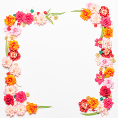 Frame made of rose flowers on white background. Top view with copy space.